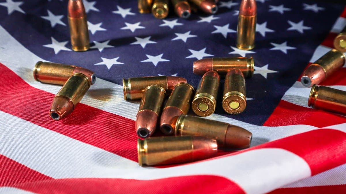 Close-up of ammunition on the American flag, signifying defense and patriotism.