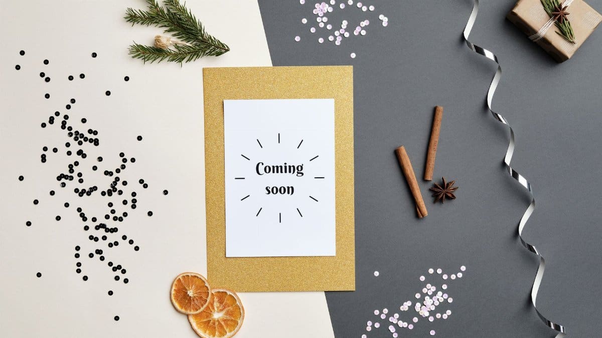 A festive holiday-themed flat lay featuring a 'Coming Soon' greeting card with decorative elements.
