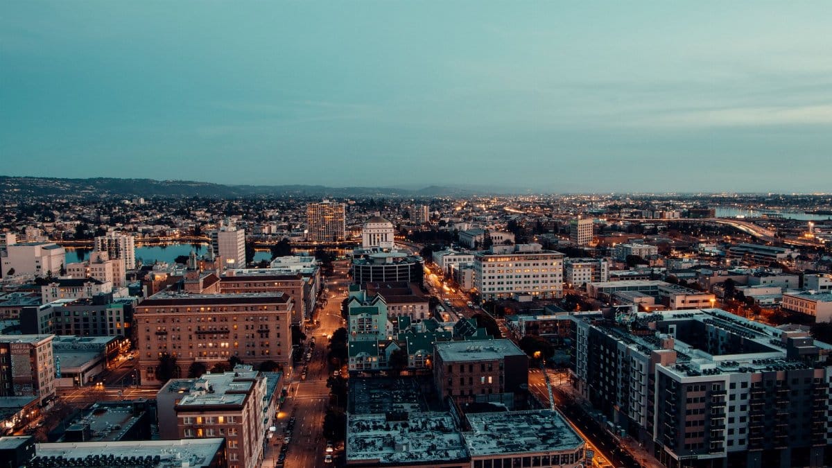 Breathtaking aerial view of a vibrant cityscape at evening dusk, highlighting urban architecture under a twilight sky.