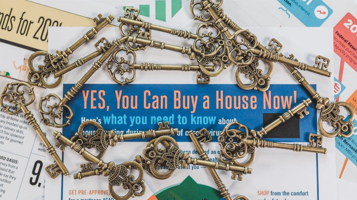 Vintage keys spread over real estate documents symbolizing property ownership and investment.