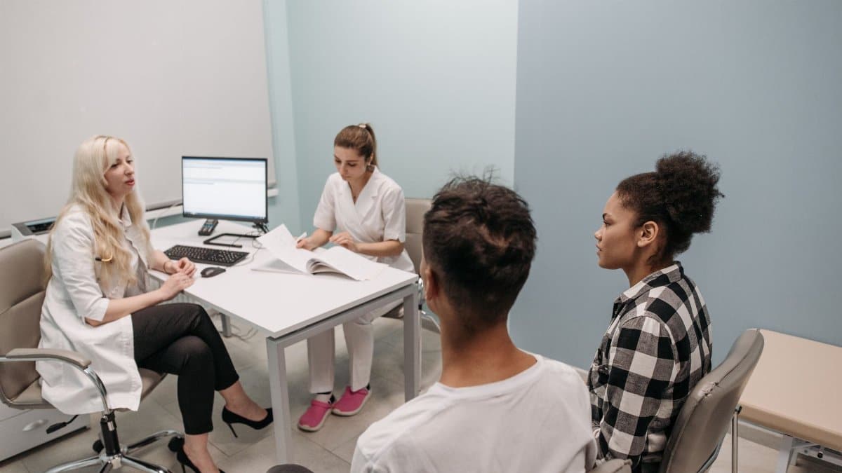 Doctor and patients during a consultation in a modern clinic, teamwork concept.