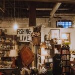 Warmly lit vintage shop interior with eclectic antiques and decor, offering a nostalgic and cozy atmosphere.