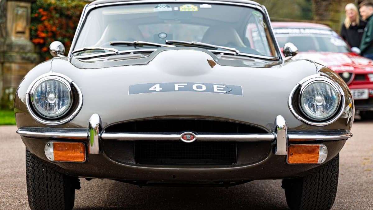Front view of iconic Jaguar E-Type at motorsport rally in Weston Park. Perfect for classic car enthusiasts.
