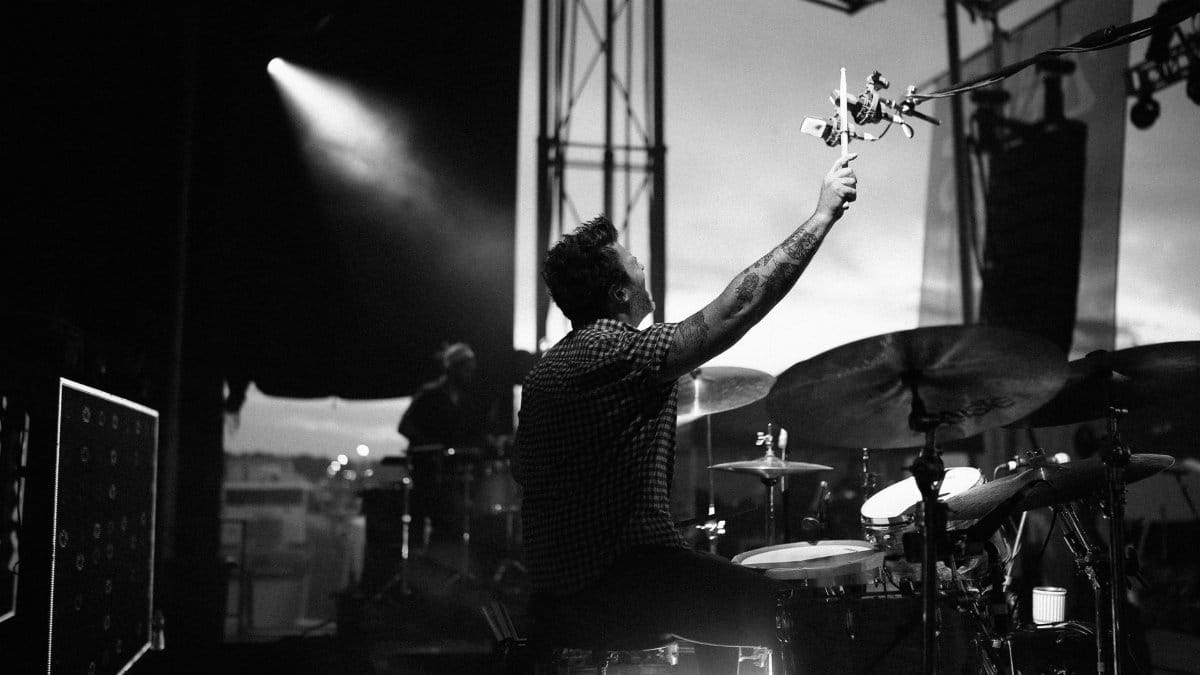 Black and white photo of drummer in action at a live concert.