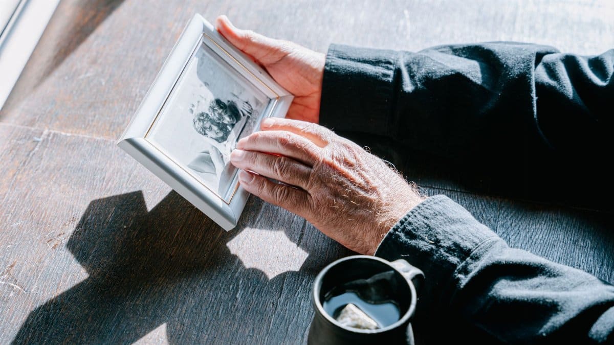 Hands holding a photo frame, symbolizing remembrance and nostalgia.