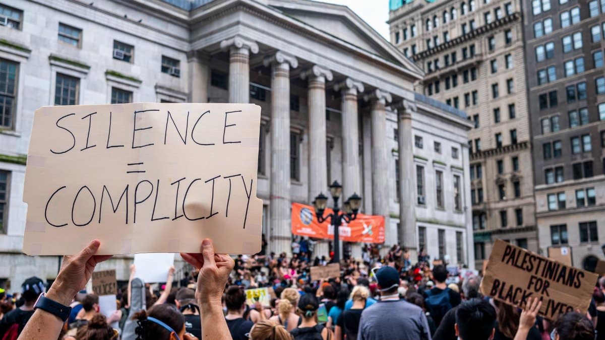 A large crowd gathers for a political protest at Brooklyn Borough Hall.