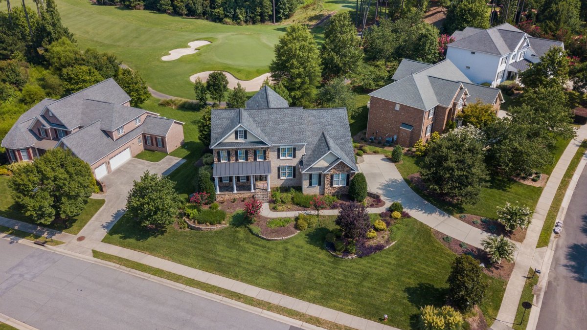 Aerial shot showcasing suburban homes and lush greenery in Raleigh, NC.