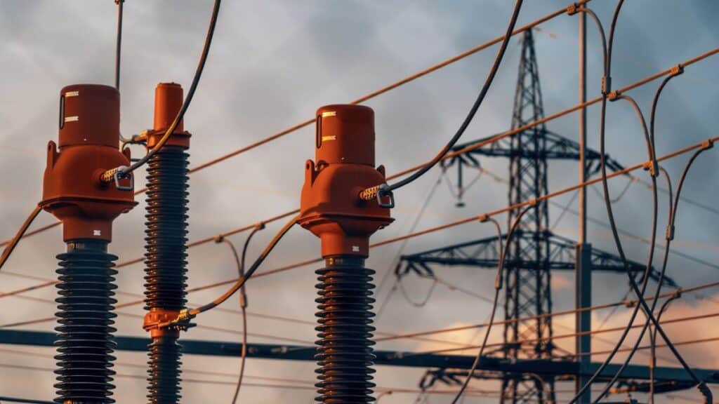 Detailed view of power transformers and lines against a sunset sky in Austria.