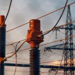 Detailed view of power transformers and lines against a sunset sky in Austria.