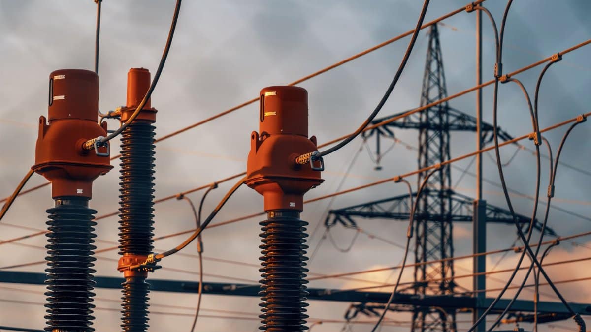 Detailed view of power transformers and lines against a sunset sky in Austria.
