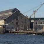 Explore the historic Boston Navy Yard with its iconic waterfront architecture and shipyard scenery.