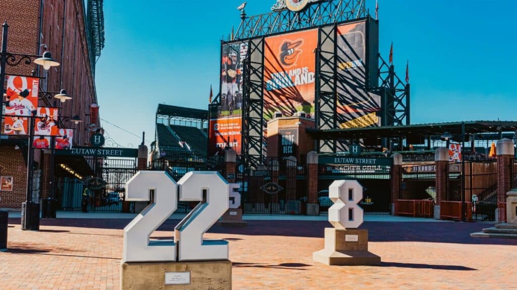 View of Eutaw Street entrance at Camden Yards adorned with Baltimore Orioles signage and team monuments.