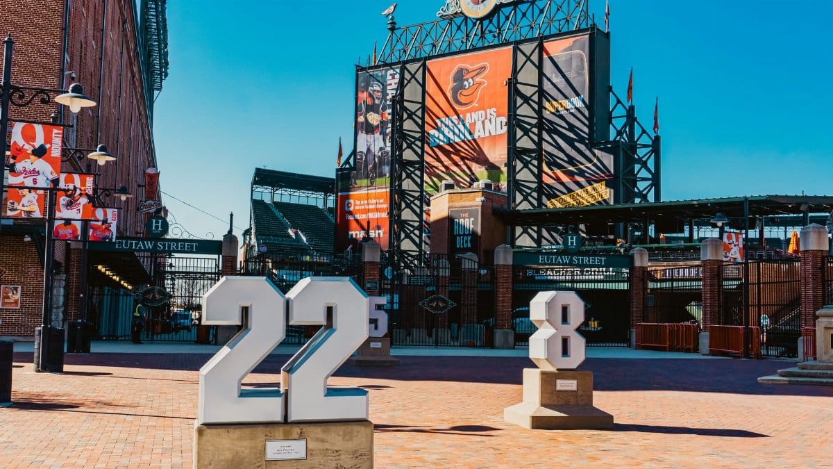 View of Eutaw Street entrance at Camden Yards adorned with Baltimore Orioles signage and team monuments.