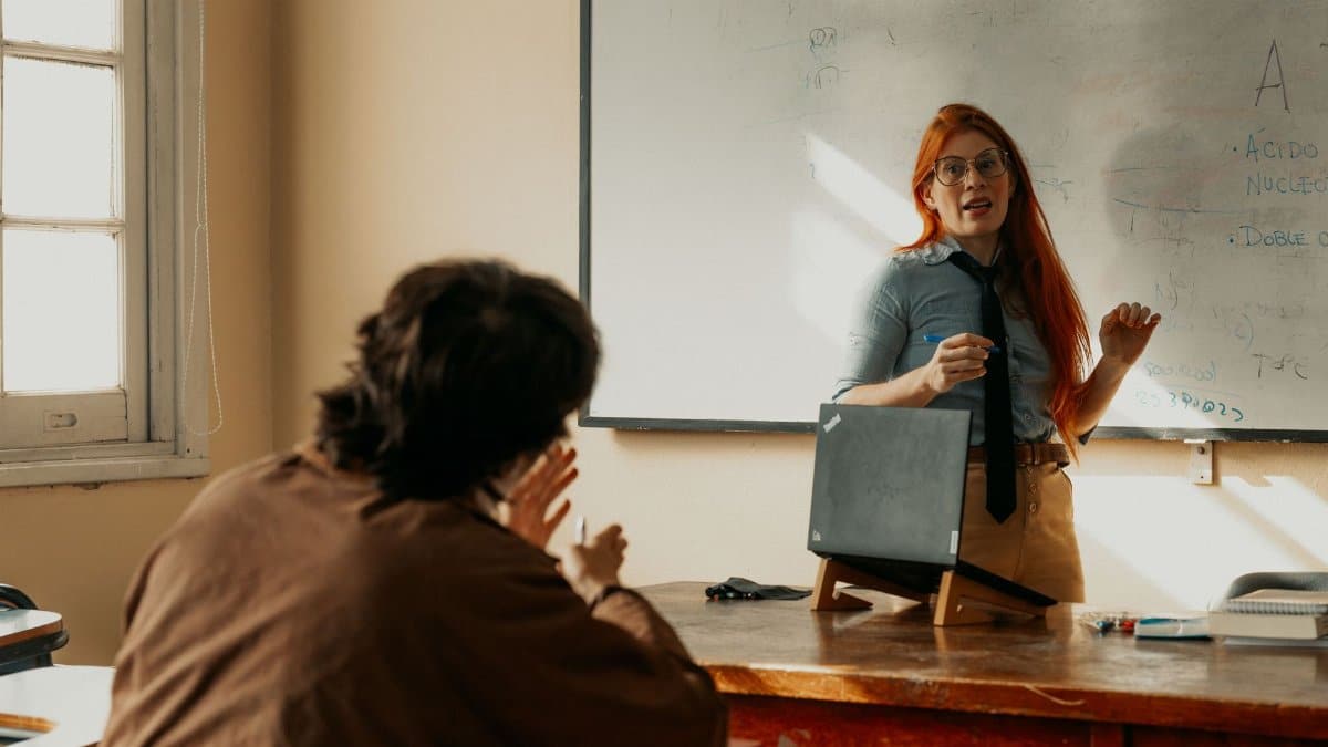 Teacher engages with student during a lesson at a Buenos Aires university classroom.