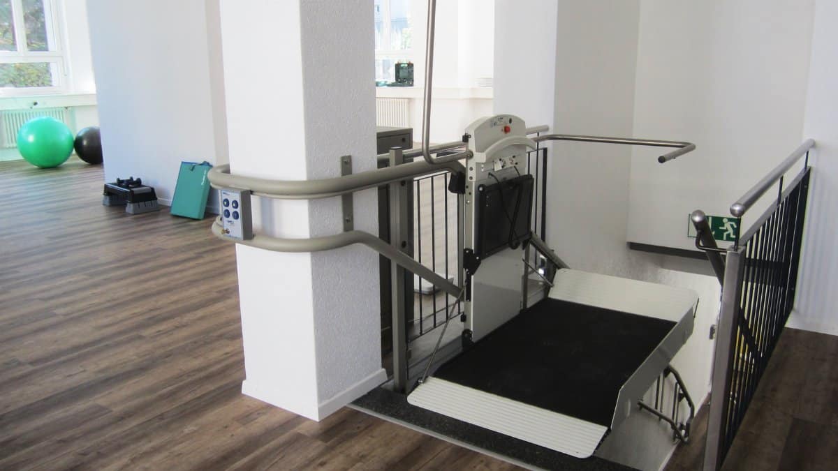 Platform lift in a rehabilitation facility promoting handicap accessibility and mobility aid support.