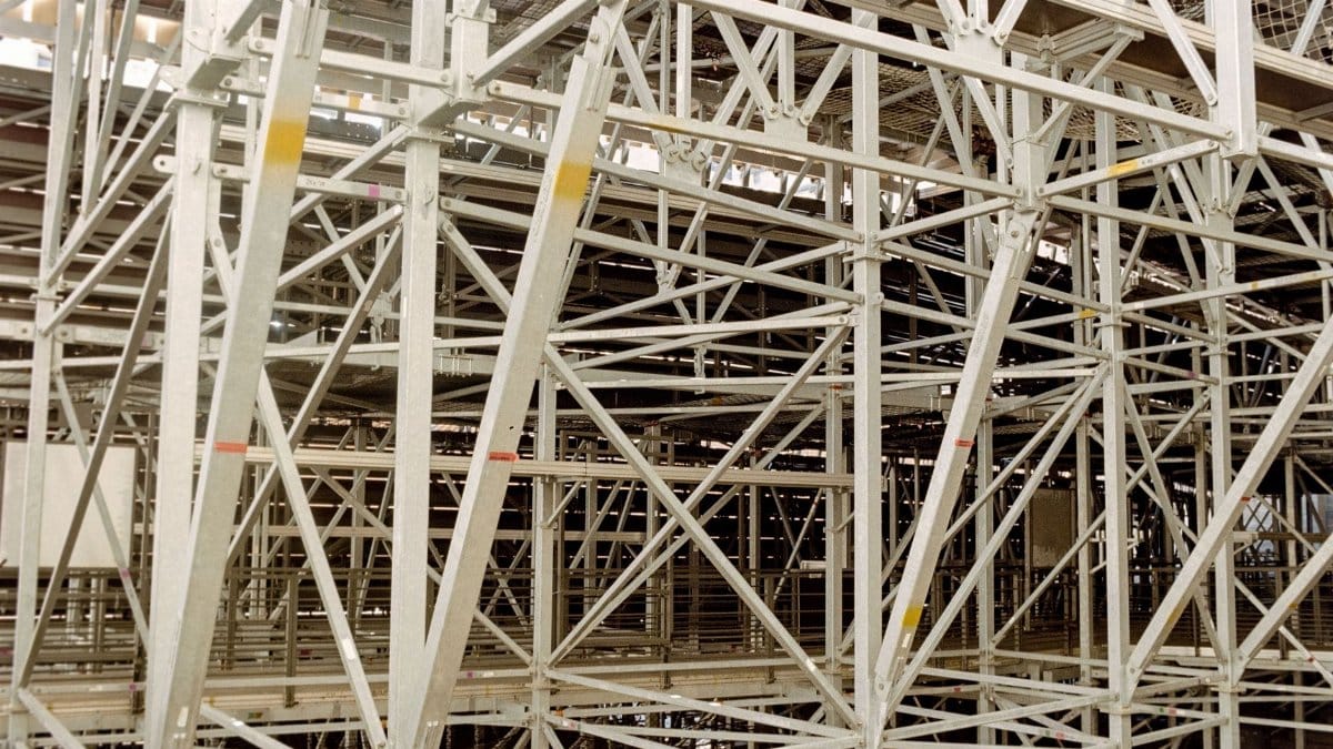 Intricate metal scaffolding structure indoors, showcasing robust industrial architecture.