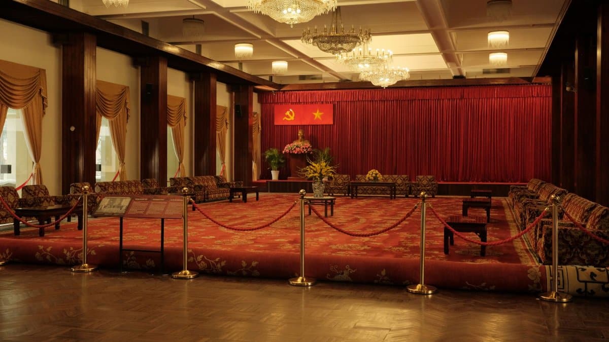 Lavish banquet hall inside the Independence Palace in Ho Chi Minh City with red carpet and chandeliers.