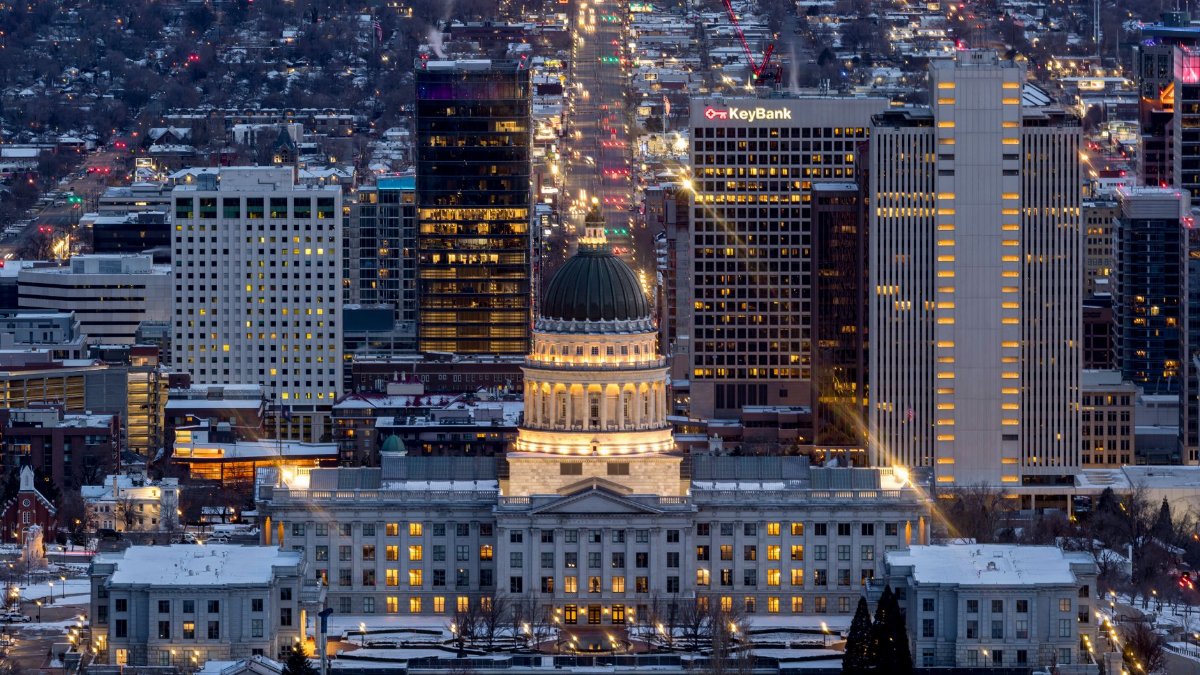 A breathtaking view of Salt Lake City's skyline illuminated at night, featuring the Utah State Capitol.