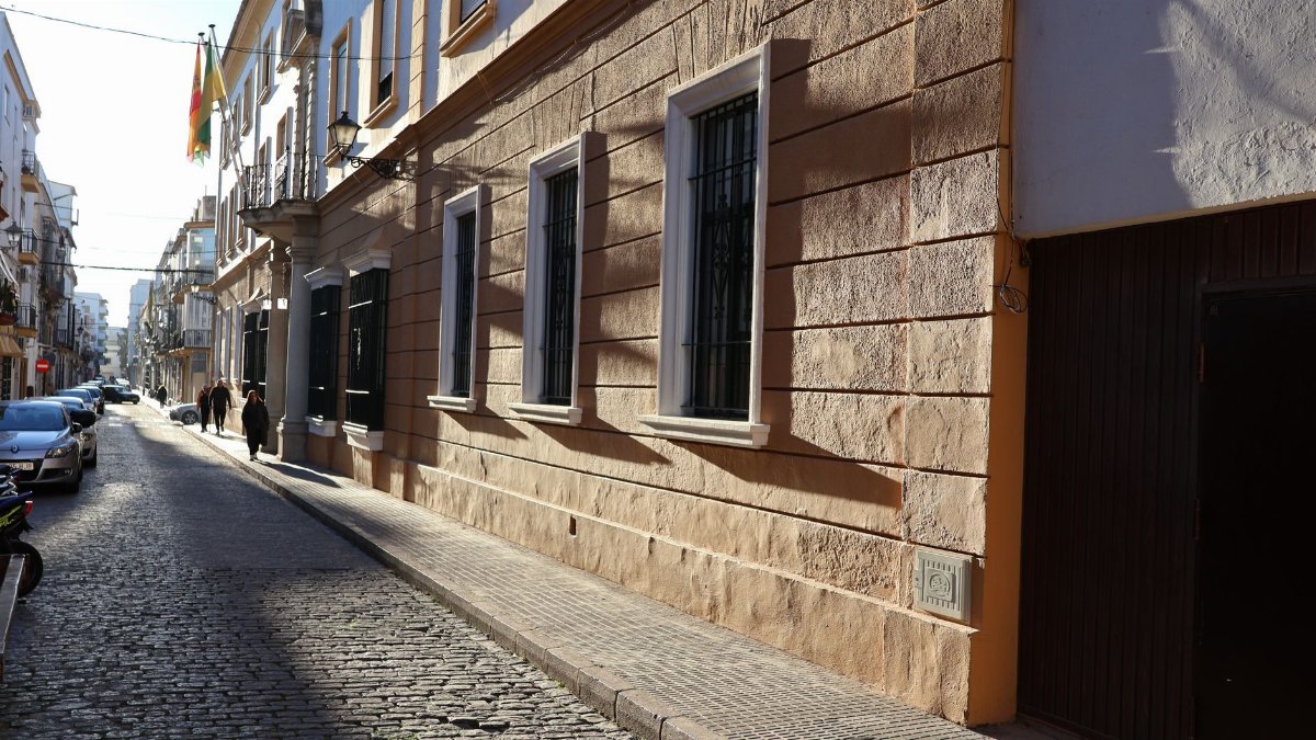 Scenic morning view of a historic cobblestone street in El Puerto de Santa María, Spain.