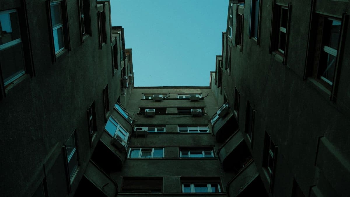 Upward shot of residential building showing dramatic lines and minimalist Soviet architecture.