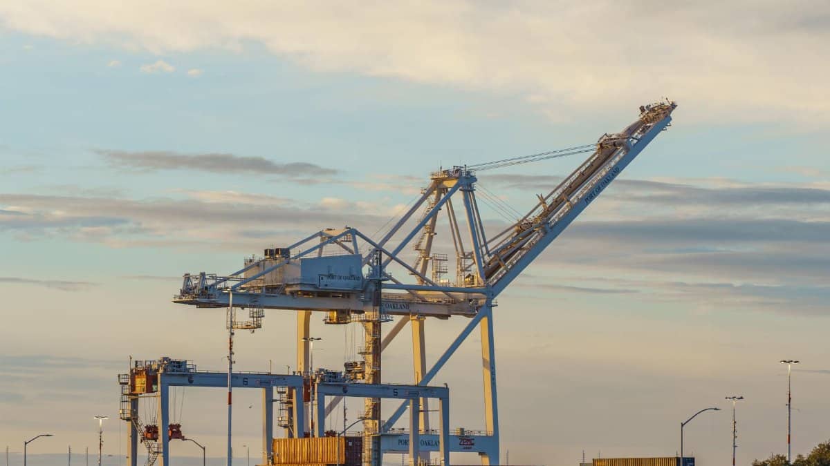 A large industrial crane at a container port during sunset, capturing the essence of industrial operations.