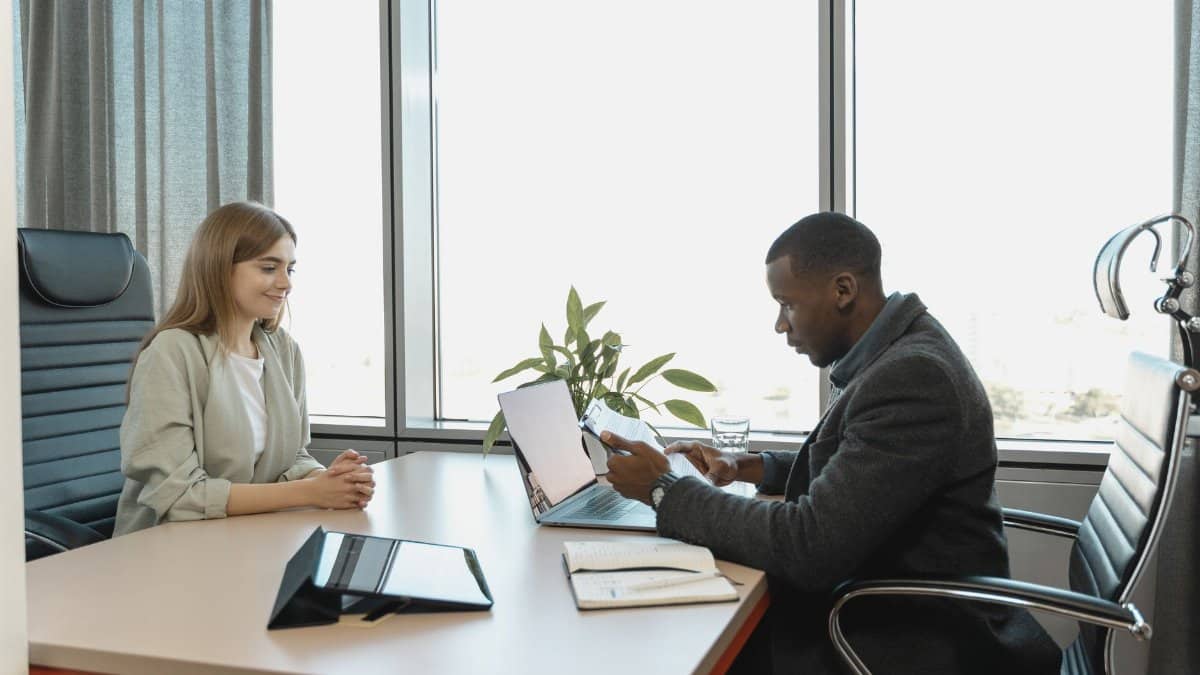 Business meeting with diverse professionals discussing a job opportunity.