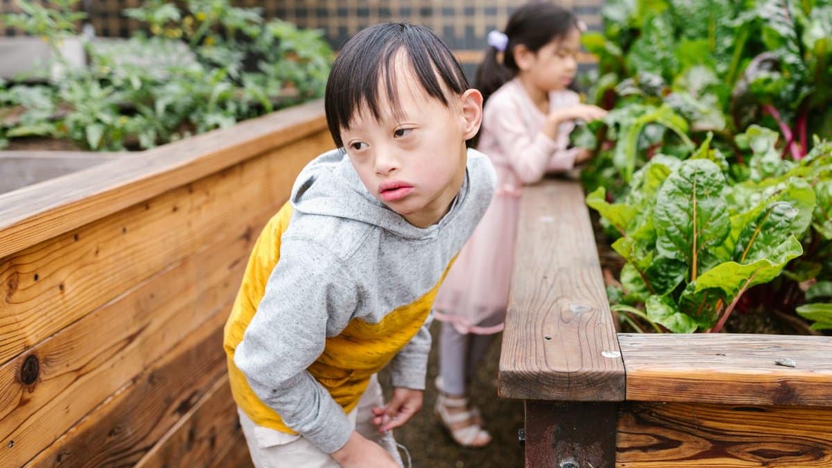 Children with Down syndrome enjoying a garden experience.