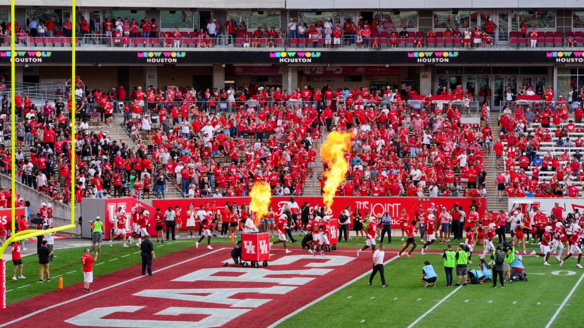 Houston college football match with vibrant crowd and fire effects. Captures the sports spirit.