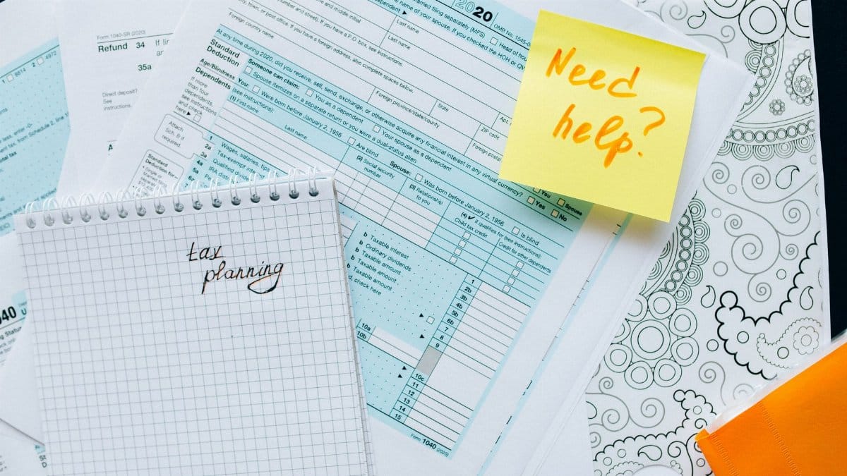 Tax documents and a note suggest tax planning and assistance needs.