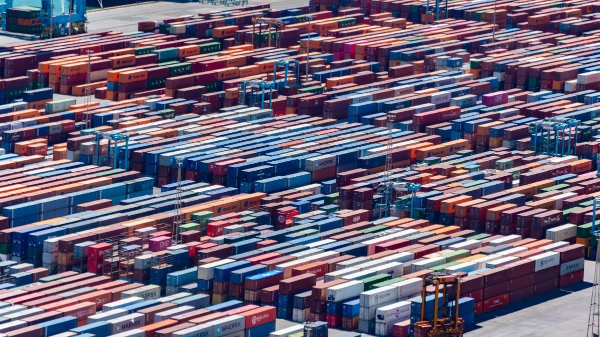A bustling port with colorful cargo containers, aerial view showcasing global trade.