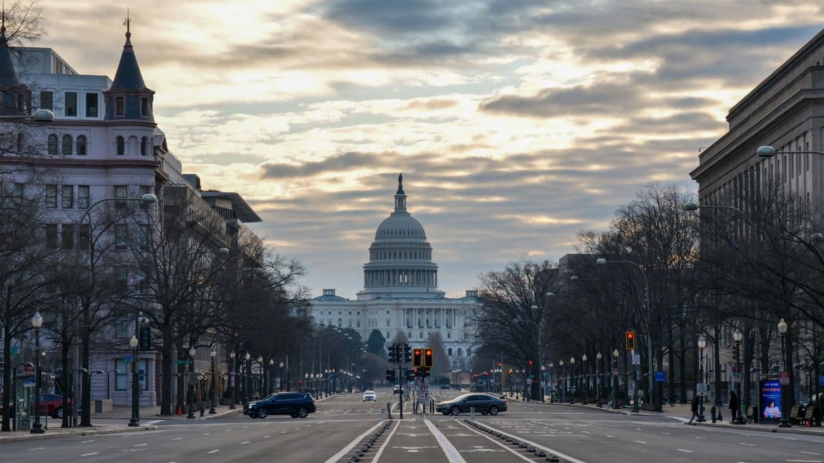 The US Capitol Building captured from a street view in Washington D.C. at sunrise.