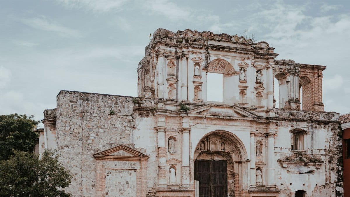 Aged cathedral facade in Antigua Guatemala, showcasing rich historical architecture.