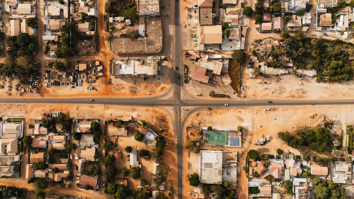Aerial view of a city's grid layout with buildings and roads intersecting.