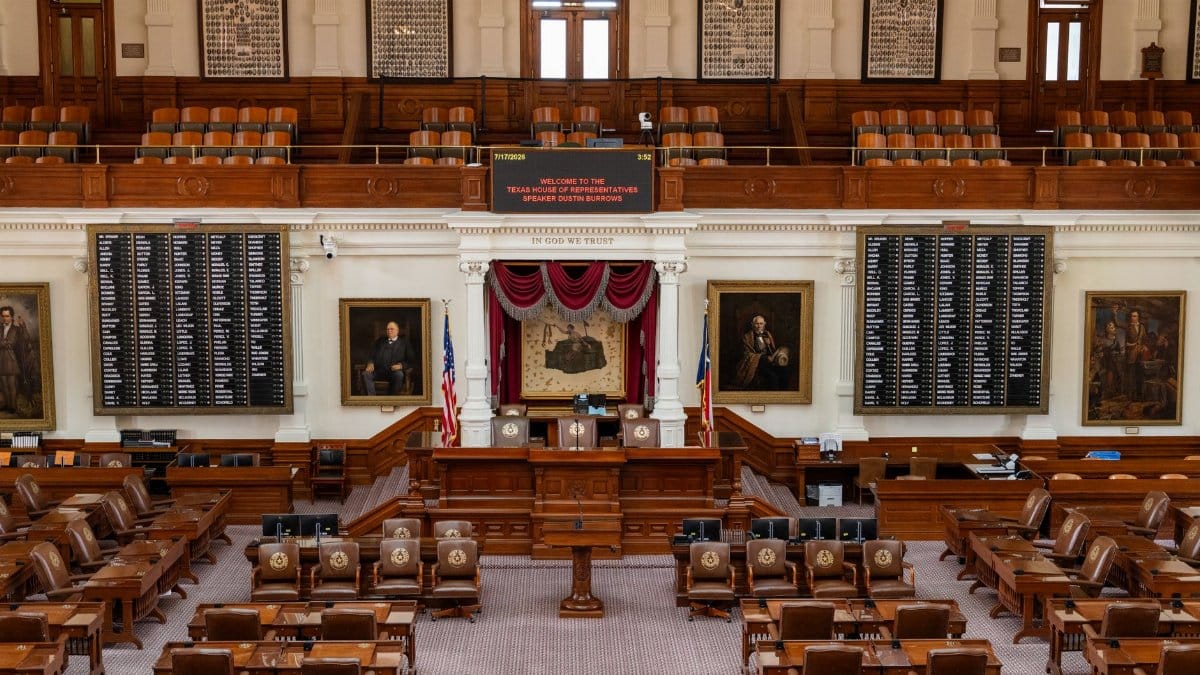 The Texas House of Representatives chamber, featuring legislative seats and historical portraits.