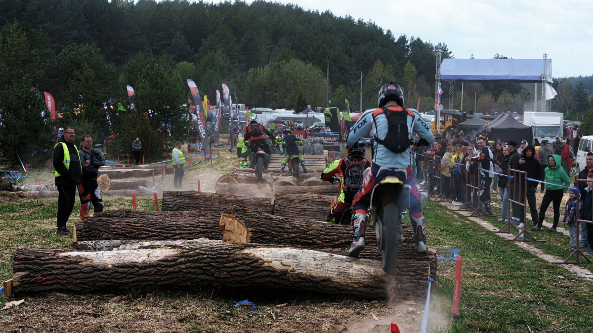 Dirt bike racers tackling obstacles at an outdoor event in Volkovysk, Belarus.
