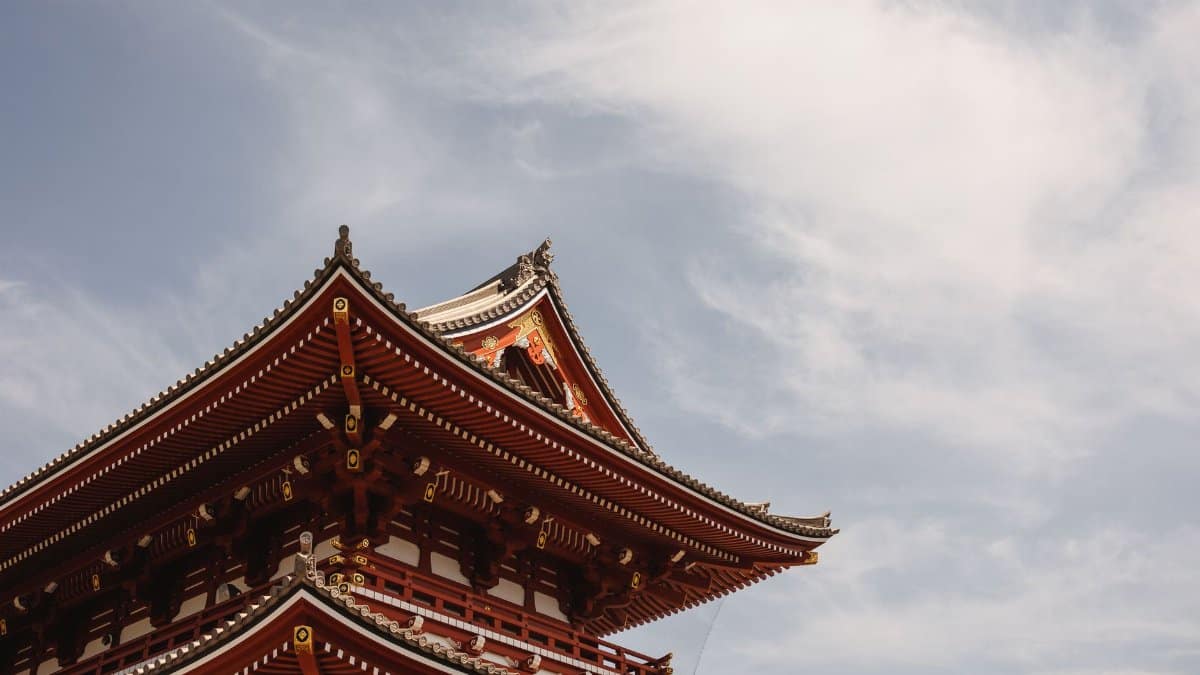 Low angle view of Senso-ji Temple roof in Tokyo, Japan against the clouds.