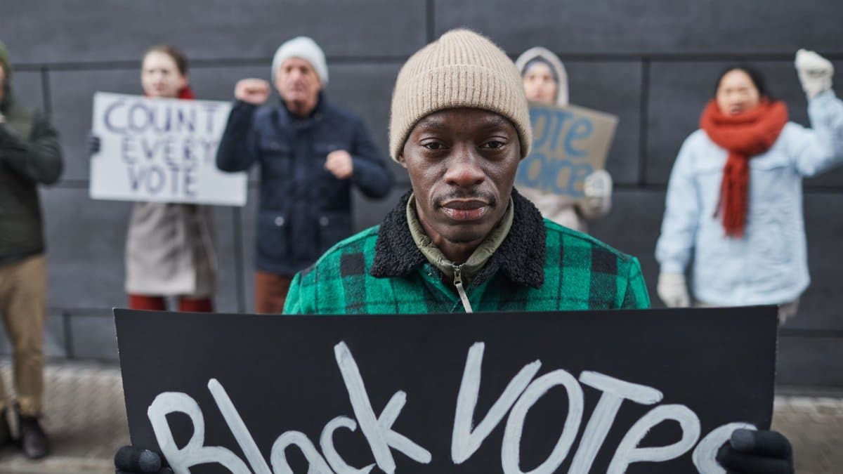 A diverse group of protesters rally for voting rights and equality during winter.
