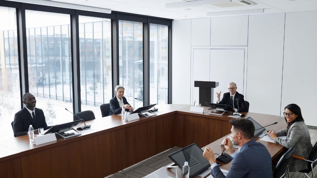 Professionals engaged in a collaborative discussion at a modern office conference room.