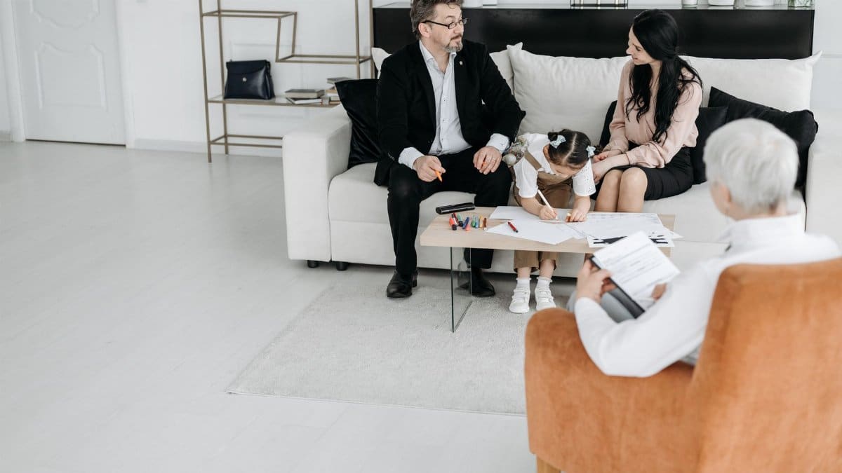 A family discussing adoption plans with a social worker in a cozy office environment.