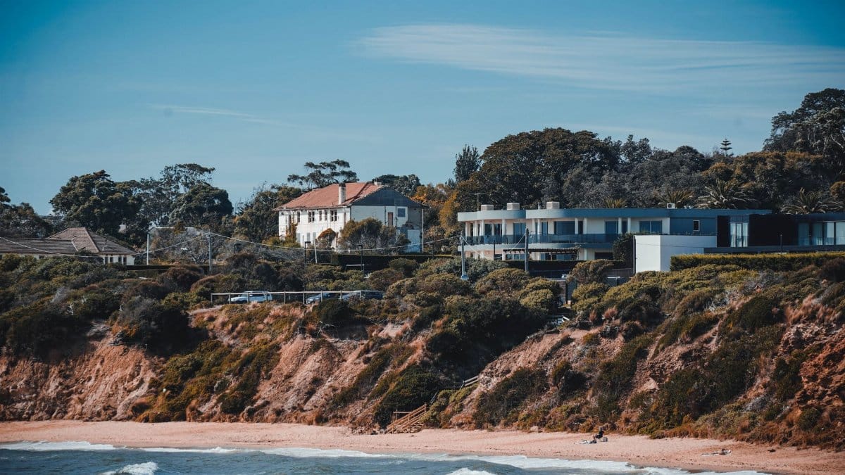 A picturesque view of coastal houses atop a scenic beach, exuding tranquility.