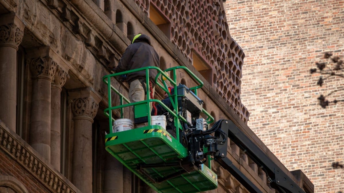 High-rise building restoration project using modern lift equipment.