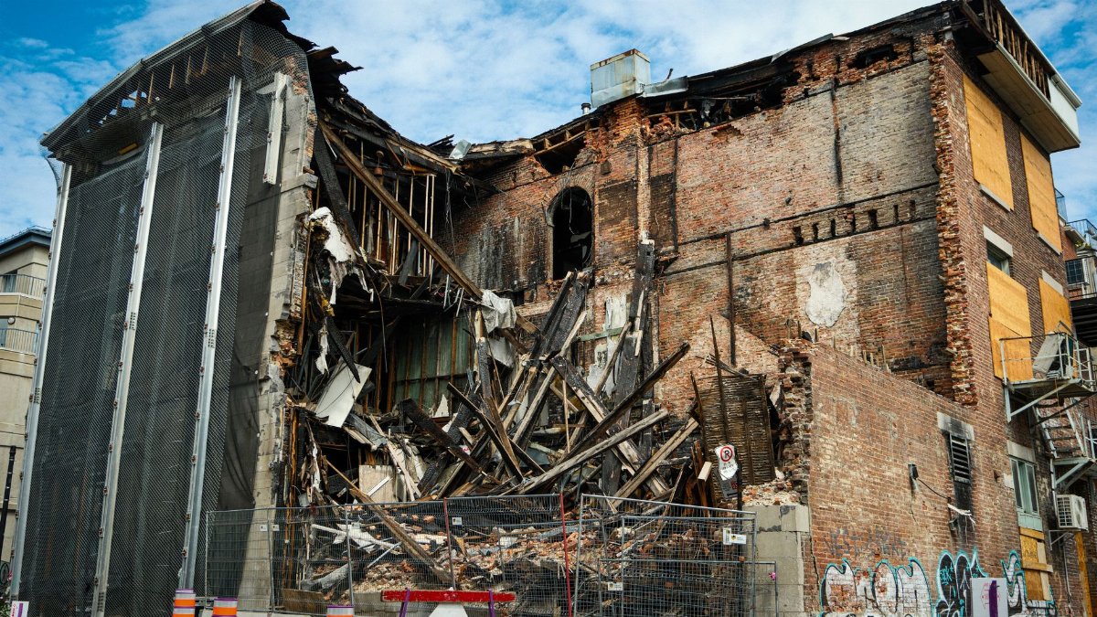 Scene of a partially demolished brick building in Montreal, showcasing urban decay and redevelopment.