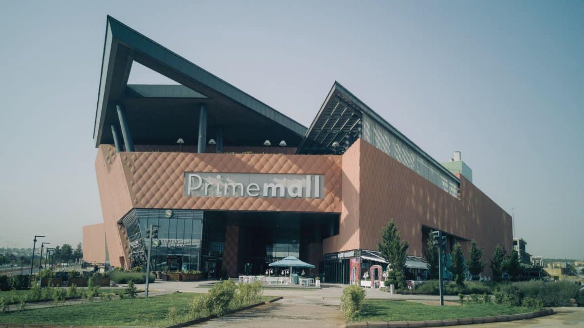 Exterior of modern Prime Mall shopping center in urban Turkey, showcasing architectural design.