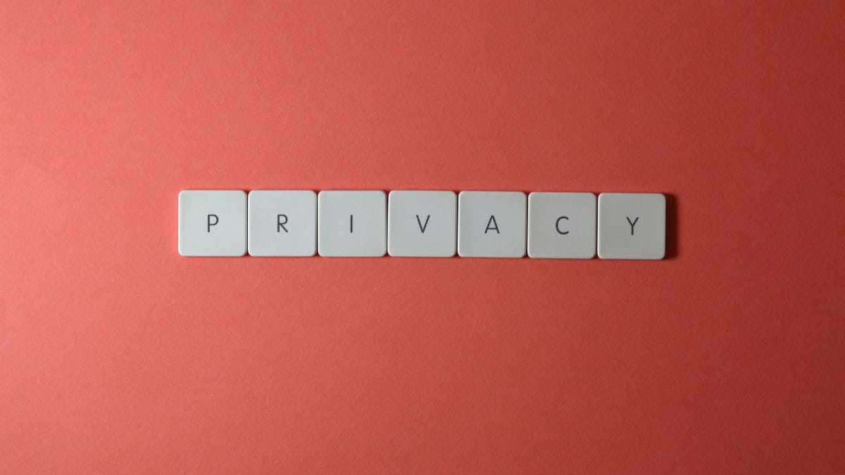 Close-up of letter tiles spelling PRIVACY on a red background, symbolizing data protection.
