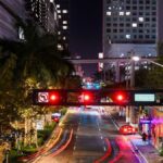 Vibrant night scene of South Miami Avenue with light trails and illuminated buildings.
