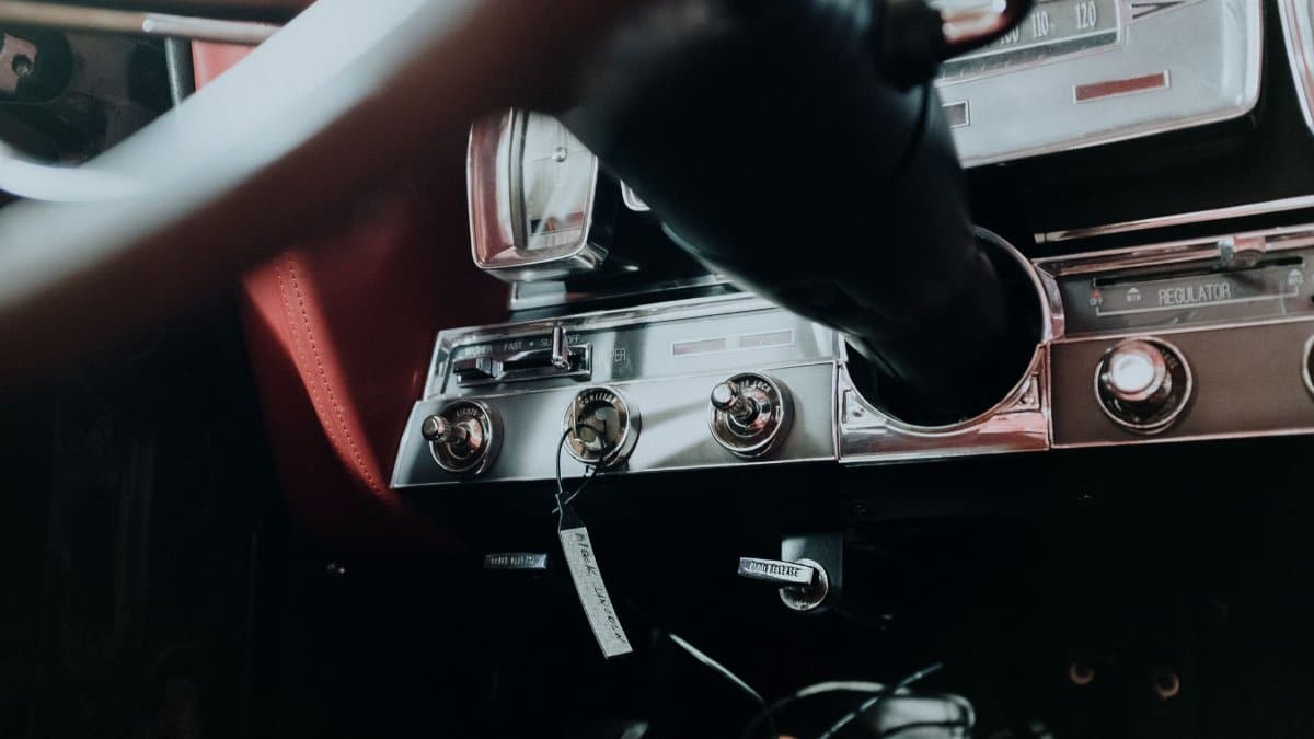 Close-up of a vintage car dashboard showcasing classic instruments and design elements.