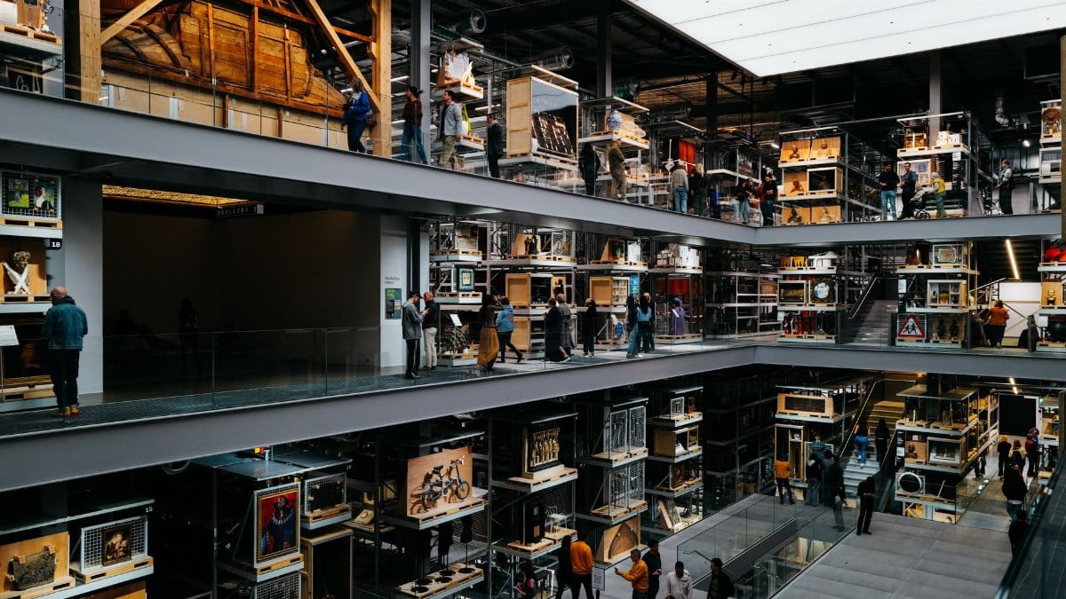 Explore the dynamic interior of a modern multi-level museum showcasing diverse exhibits with a vibrant public atmosphere.