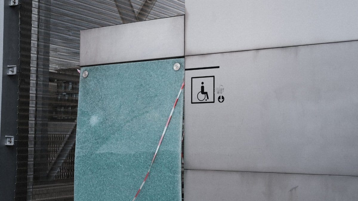 Urban architectural facade featuring an accessibility symbol for wheelchair access.