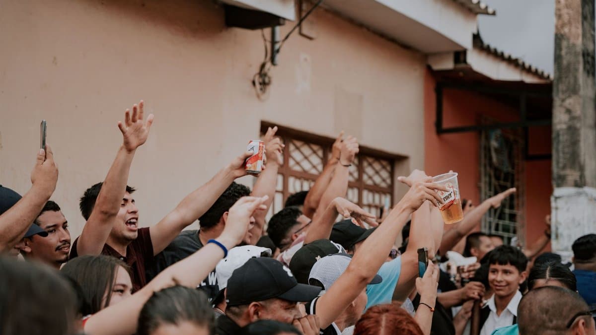 A lively crowd gathers in an urban street celebration, capturing the essence of community joy.