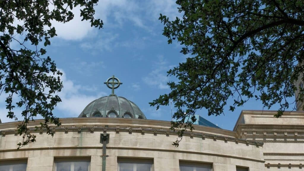 Beautiful view of a church dome framed by tree branches under a blue sky in Fort Worth, Texas.